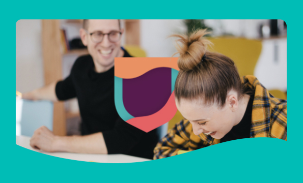 Man and woman at table with shield icon.